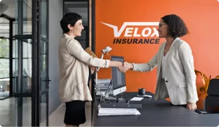 Velox Insurance representitive with a customer.